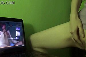 She experiences a dry humping orgasm while watching porn at home.