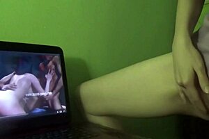 She experiences a dry humping orgasm while watching porn at home.