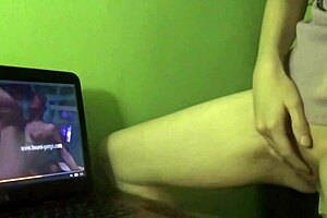 She experiences a dry humping orgasm while watching porn at home.