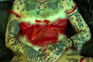 Tattooed milf with glasses and piercing achieves solo orgasm on shelf during Christmas