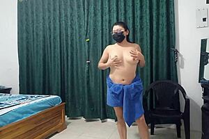 My 50-year-old stepmother with delicious natural tits modeling in a towel for me