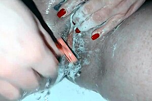 A hot mature woman is shaving her sweet pussy in a steamy scene