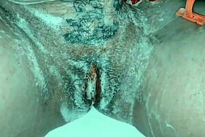 A hot mature woman is shaving her sweet pussy in a steamy scene