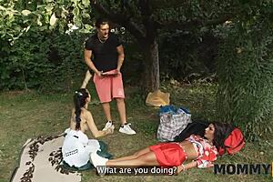 A horny mommy sneaks to fuck a young cock on the grass