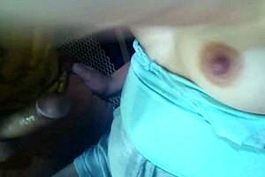 Playing with her breasts in an old toolshed