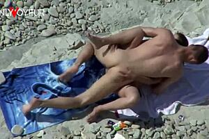 Busty cougar rides hard dick on beach, gets facial.