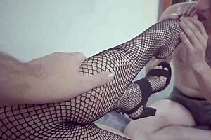 IN THIS HOT THREESOME, THE WIFE GIVES A FOOTJOB LEADING TO DOUBLE CUMSHOT ALL OVER HER BIG TITS