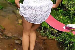 Bent over brunette in dress pulls it up to reveal no panties for jerk off instructions!