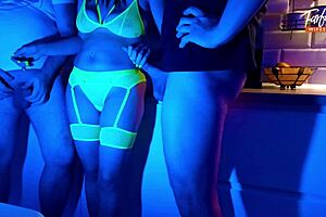 Wife eagerly sucks two cocks in neon threesome. She swallows cum and gets facial.