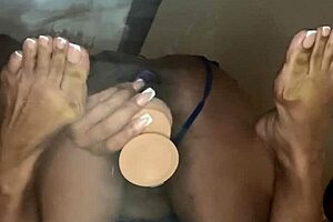 This ebony friend casually takes a dildo deep in her pussy. She rides it solo on the desk like a pro.