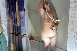 Relaxing shower with natural tits and pierced nipples.