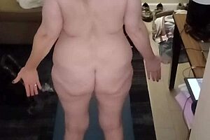 The hot milf with big natural tits performs naked yoga routines. She stretches gracefully in various poses.