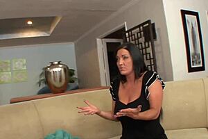 Older mom Sammy Brooks strips naked on bed with Bella for shaved pussy fingering and anal play in lingerie and heels.