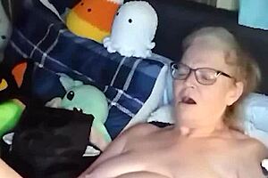 Curvy mature woman performs naked yoga in her room. She spreads legs wide and fingers her saggy tits until orgasm hits.