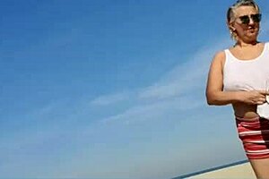 Far out! This sexy African milf flashes big natural tits and pussy lips on the beach.