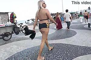 Walking in mini short along Copacabana beach drawing looks from men