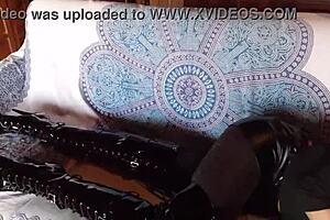 Petite brunette milf in sexy total black outfit with fishnets pantyhose and over-the-knee boots