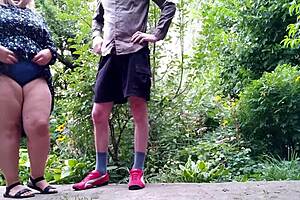 My mature mother-in-law pees standing up outdoors with her huge tits and big ass exposed! 😲💦