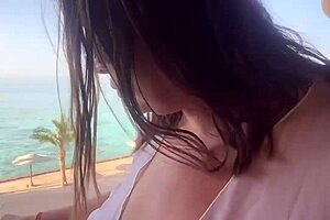 Hairy pussy masturbates on outdoor balcony. She reaches squirting orgasm with moans.