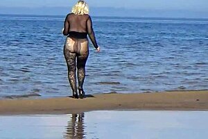 black style milf flashes big tits on the beach