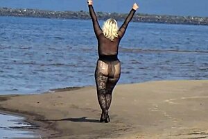 black style milf flashes big tits on the beach