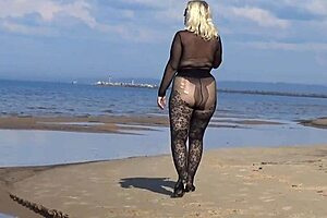 black style milf flashes big tits on the beach