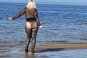 black style milf flashes big tits on the beach