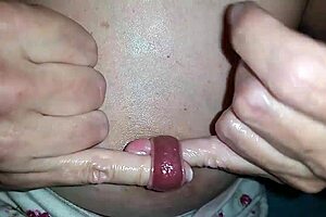 Nippleringlover, the kinky milf, fingers her extreme stretched nipple piercing. She pushes two fingers through while in bdsm slave mode.