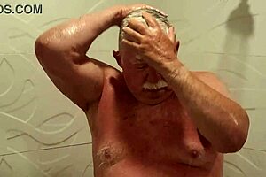 Grandpa indulges in a steamy shower, revealing unexpected allure.