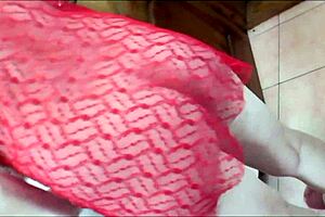 Sexy milf wife wakes up in transparent negligee without panties. She pees, dresses in bra skirt stockings high heels for solo fetish display.