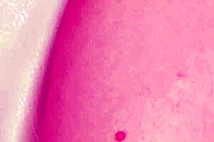 Charming blonde teen poses naked in close-up during amateur casting interview on sofa with mother in law watching.