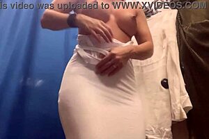damn, check out this milf with massive boobs slipping into sexy dresses on hidden cam!