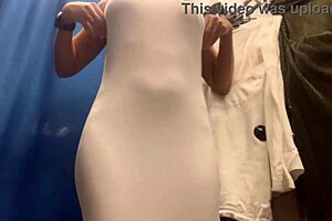 damn, check out this milf with massive boobs slipping into sexy dresses on hidden cam!