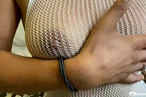 brunette in a fishnet playing with her slit