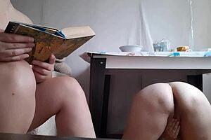 Stepdaughter Reads Book While Stepmom Masturbates Doggystyle Under Table with Wet Pussy