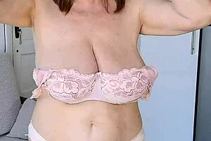 Mature woman does striptease in stockings. She plays with toy close-up on shaved pussy