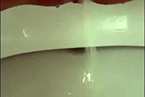 close up on shaved pussy lips pierced clit squirting wet in public toilet outdoors