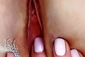 mature blonde massages her huge meaty pussy lips