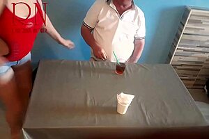 Naked waitress serves food from her navel to guest.