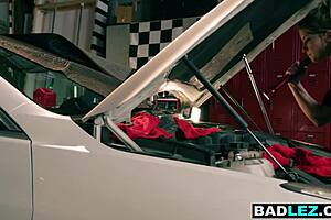 Huge ass curvy milf mechanic pounds busty blonde with strapon in oily garage romp.