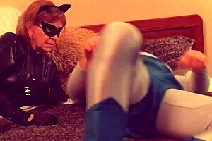 Granny Catwoman in stockings sucks moaning Batman's cock close-up
