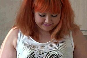 Redhead milf shakes fat ass in kitchen, masturbates with big cucumber for fetish close-ups