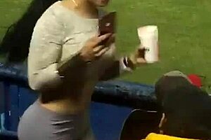 Damn, watching this milf's juicy ass shake in leggings at the stadium has me hooked!