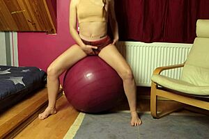fitness redhead teen rides dildo on fitball masturbates to shaved pussy orgasm