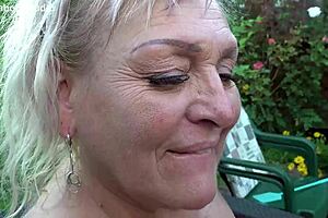 Busty chubby mature milf pumps huge cock outdoors in garden