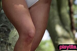 petite german milf undresses and strips naked amid forest trees