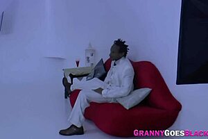 busty granny bride in white rides tall black man during ceremony