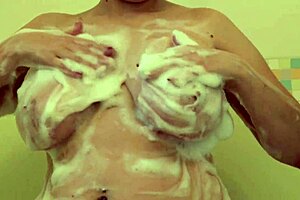 A pretty milf bathes showing big tits hairy pussy ass