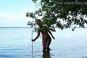Topless babe spears fish with hidden harpoon thrills