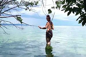 Topless babe spears fish with hidden harpoon thrills